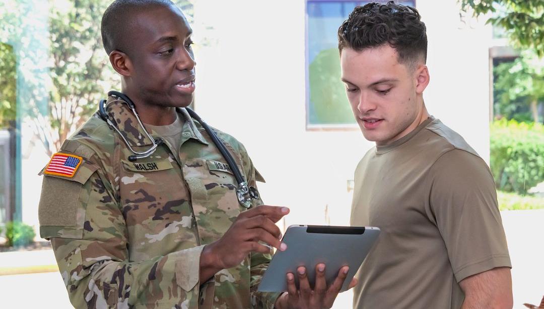 two men looking at tablet