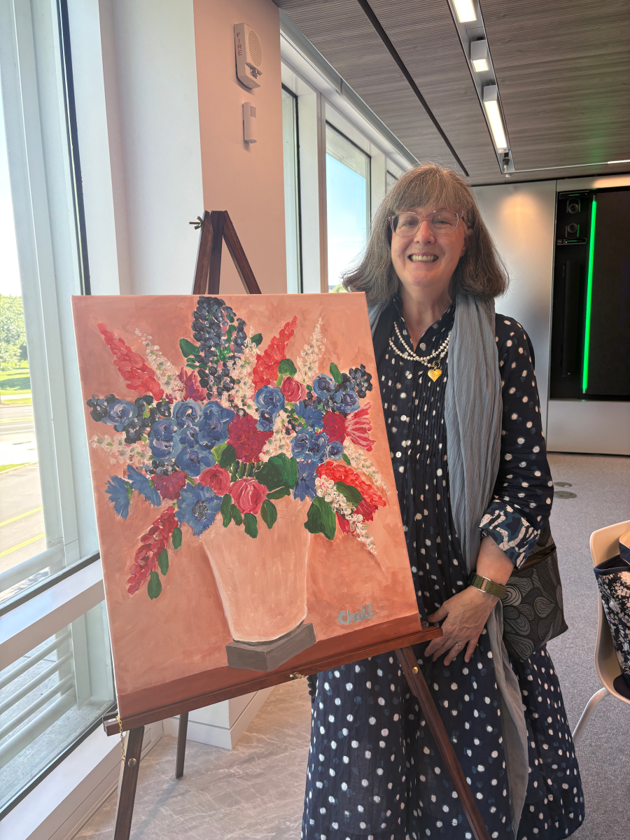 Victoria Chall standing next to a painting